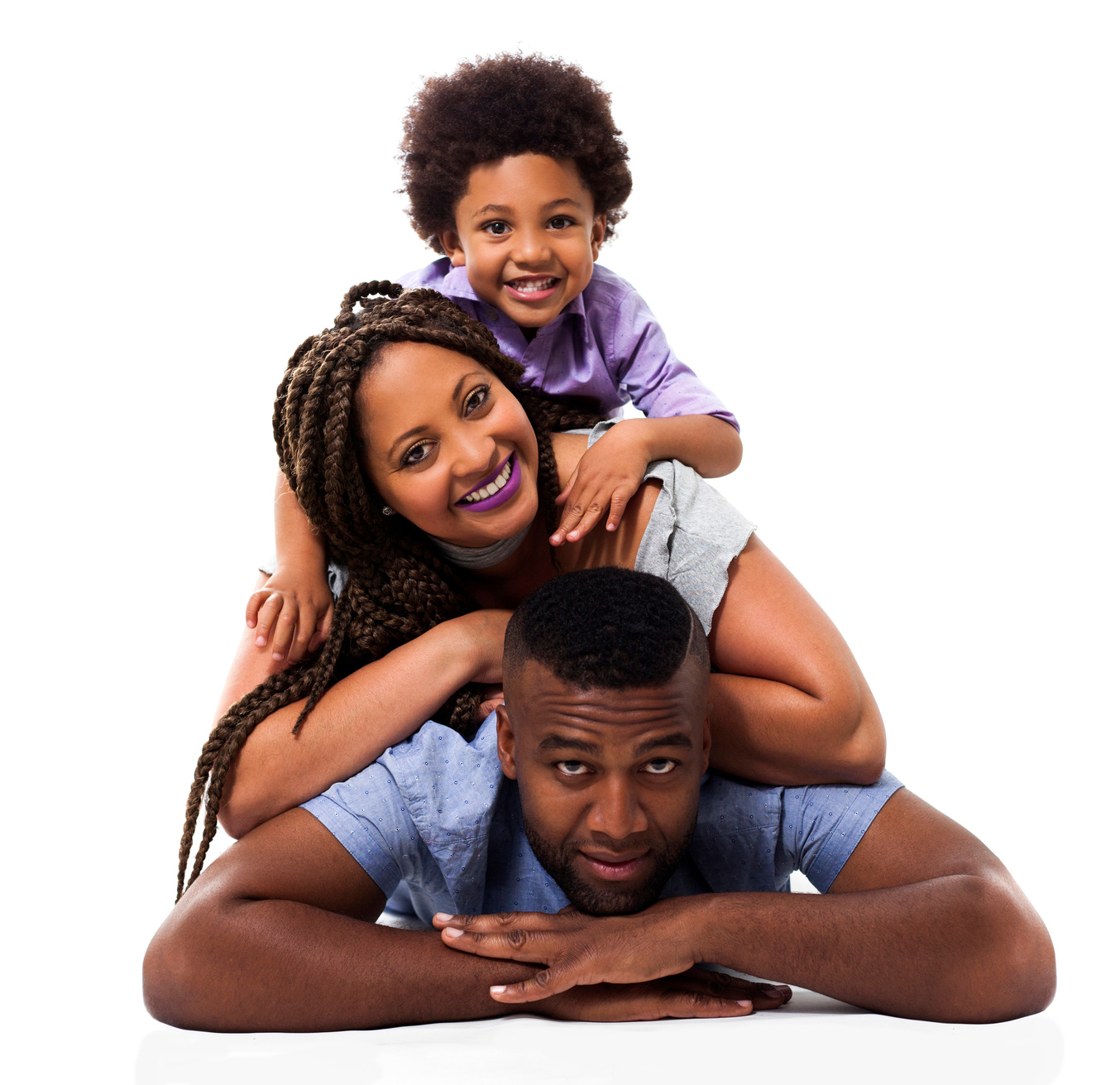 Portrait of happy black family smiling at camera while lying down
